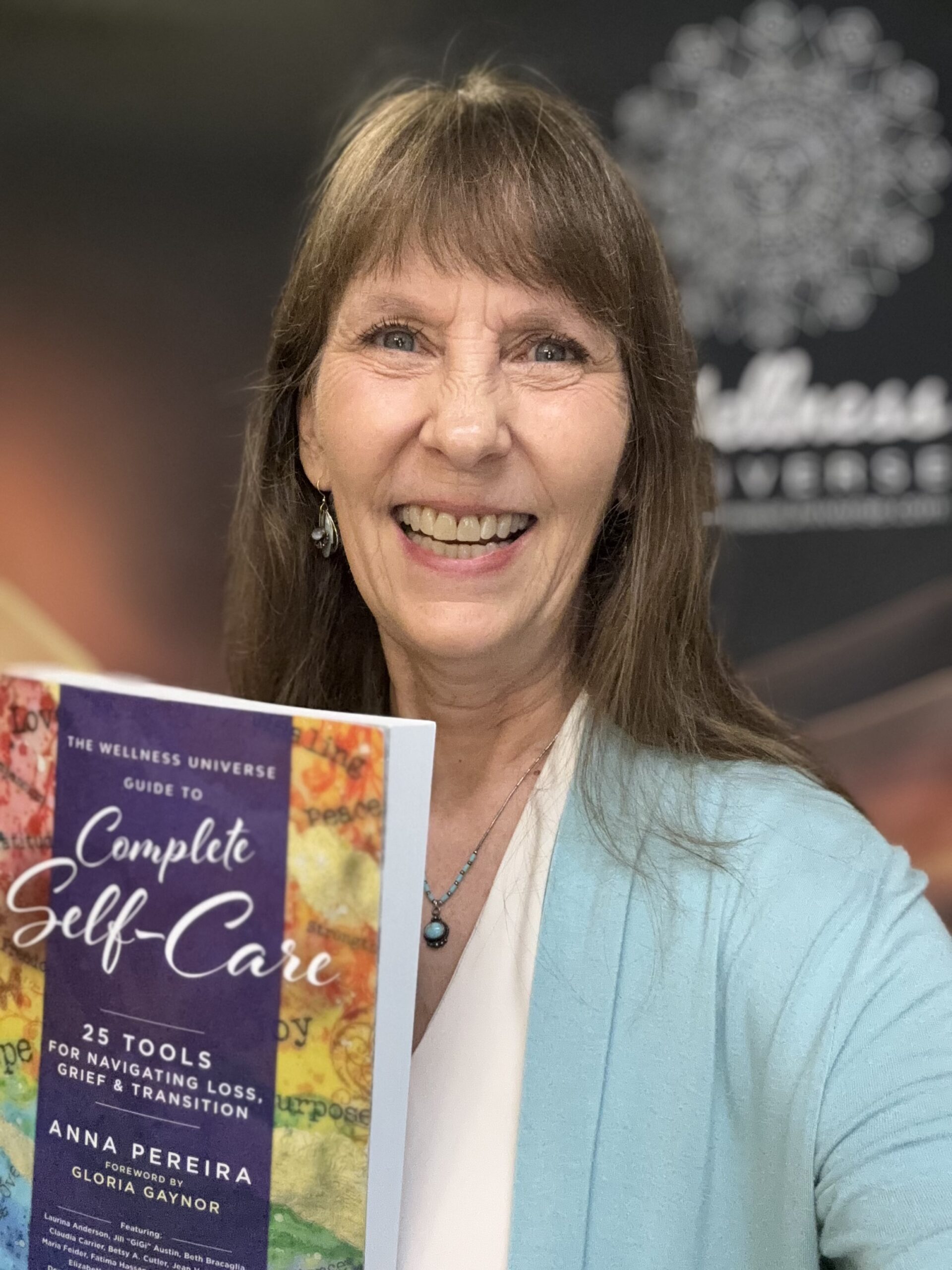Leah Skurdal holding The Wellness Universe Guide to Complete Self-Care