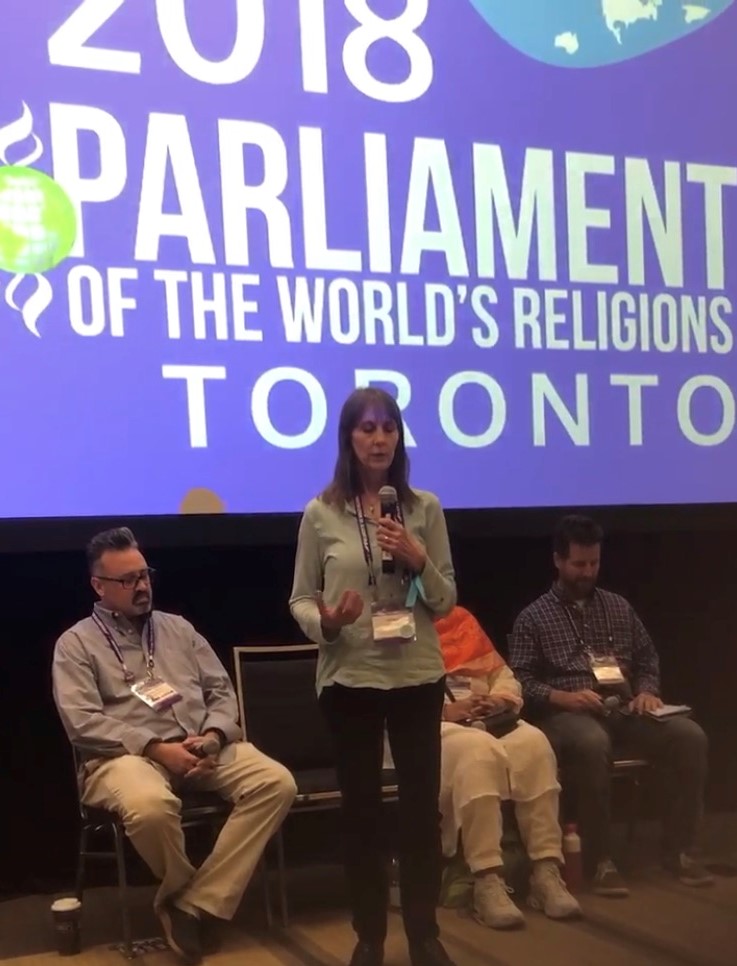 Leah Skurdal speaking on a panel at the Parliament of the World's Religions, Toronto