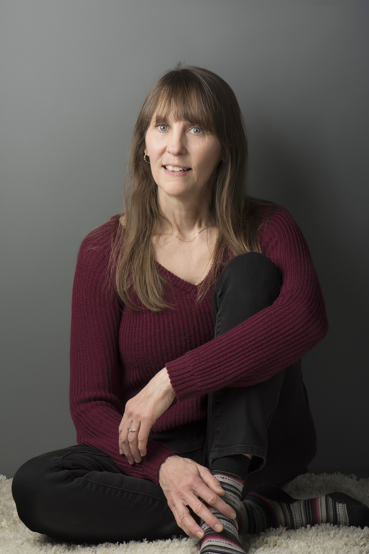 Leah Skurdal seated in a burgundy sweater