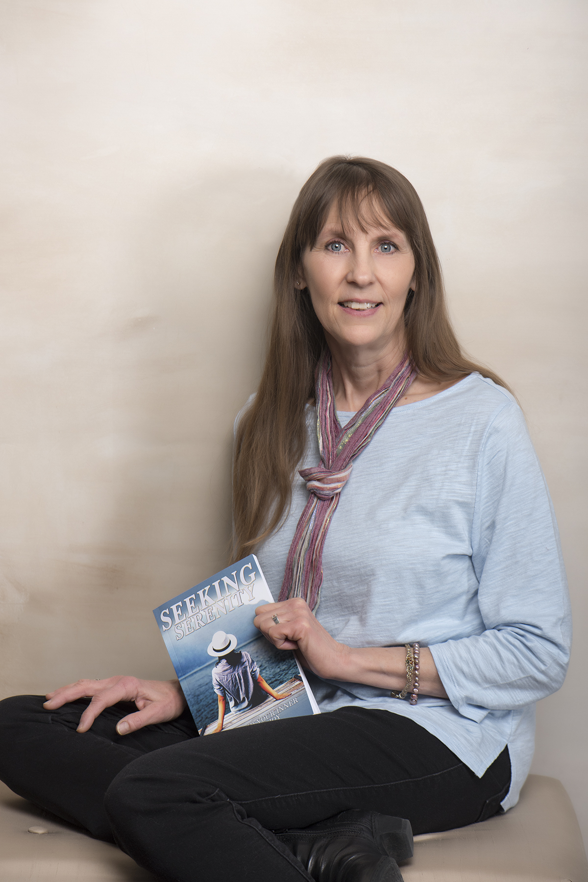 Leah Skurdal holding her book Seeking Serenity
